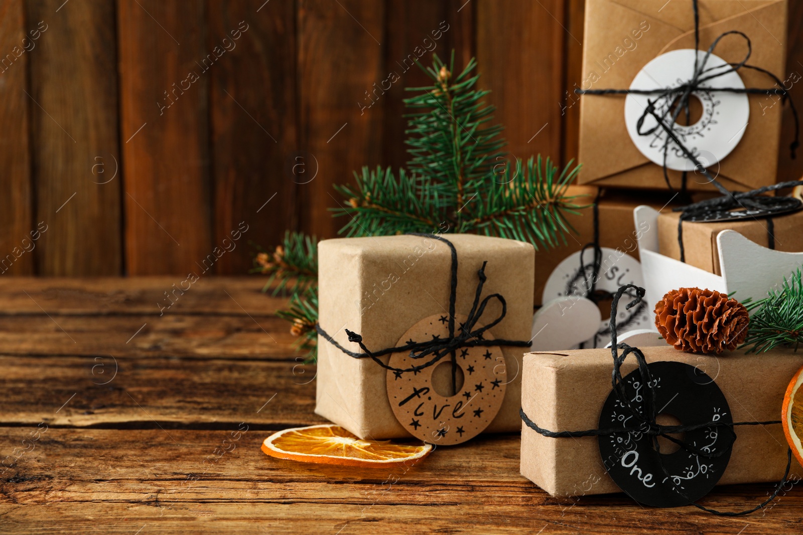 Photo of Gift boxes and festive decor on wooden table, space for text. Christmas advent calendar