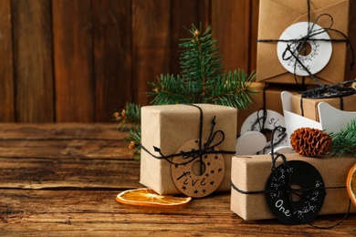 Photo of Gift boxes and festive decor on wooden table, space for text. Christmas advent calendar