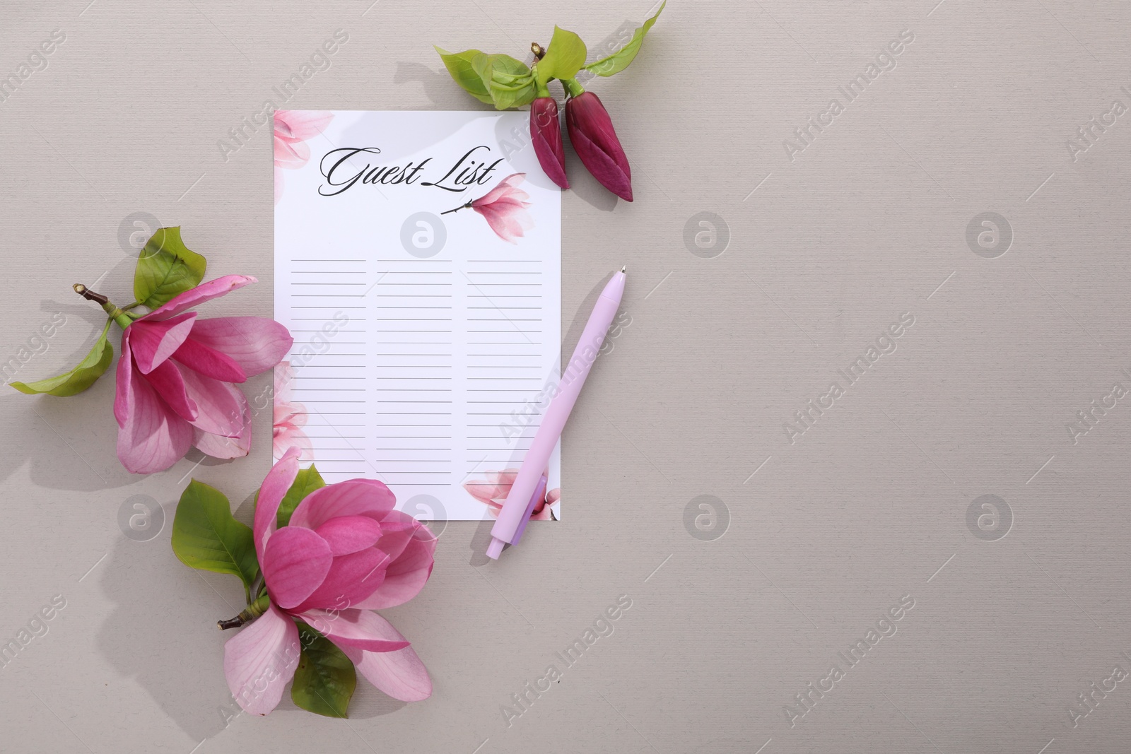 Photo of Guest list, pen and beautiful flowers on grey background, flat lay. Space for text