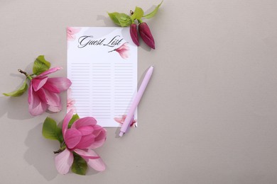 Guest list, pen and beautiful flowers on grey background, flat lay. Space for text