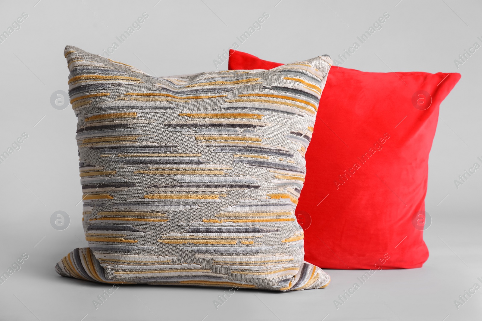 Photo of Different stylish soft pillows on grey background