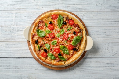 Photo of Tasty homemade pizza on wooden table, top view