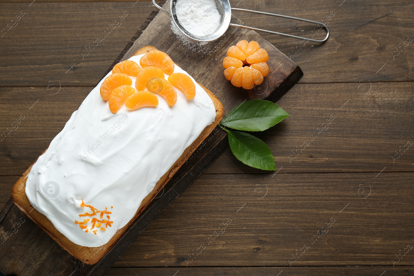 Photo of Delicious homemade yogurt cake with tangerines and cream on wooden table, flat lay. Space for text