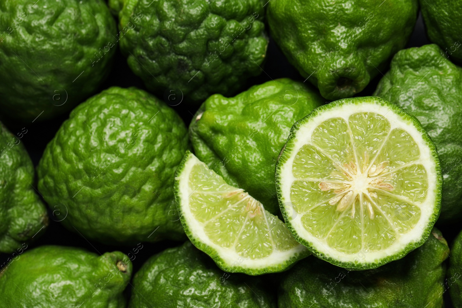 Photo of Whole and cut ripe bergamot fruits as background, top view