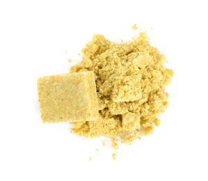 Aromatic crumbled and whole bouillon cubes on white background, top view