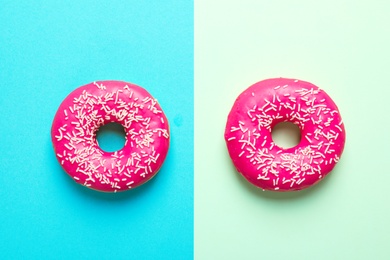 Photo of Delicious glazed doughnuts on color background, top view