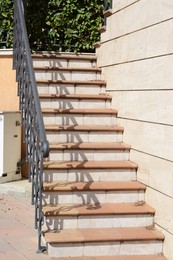 Beautiful tiled stairs with metal railings outdoors