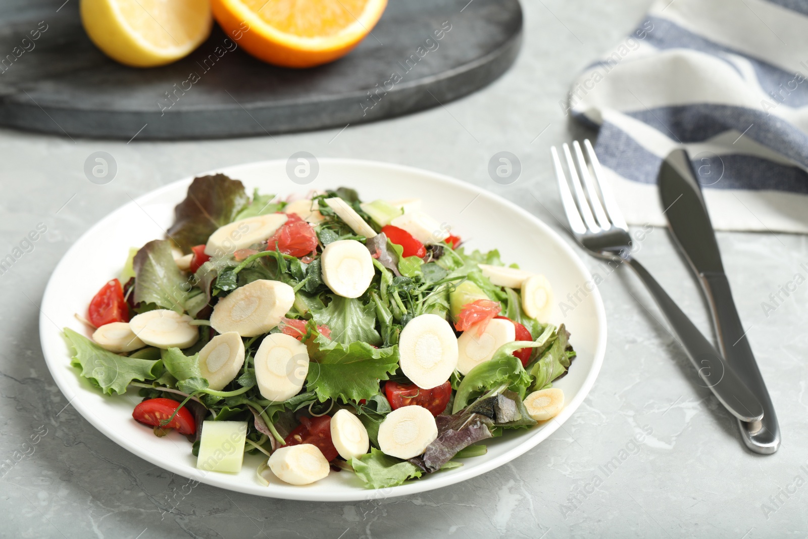 Photo of Delicious carrot salad served on grey table, closeup