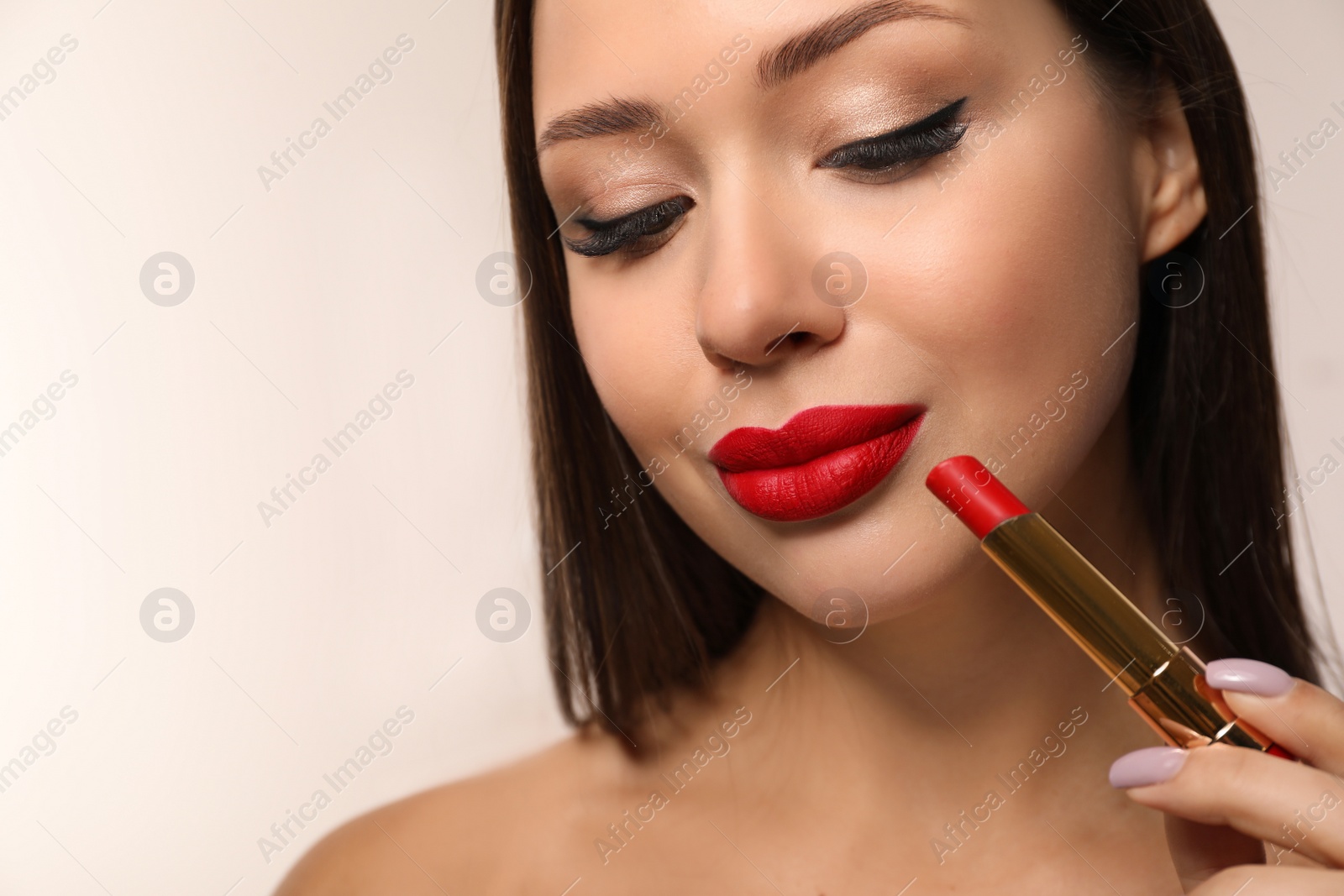 Photo of Beautiful woman with red lipstick on light background. Space for text