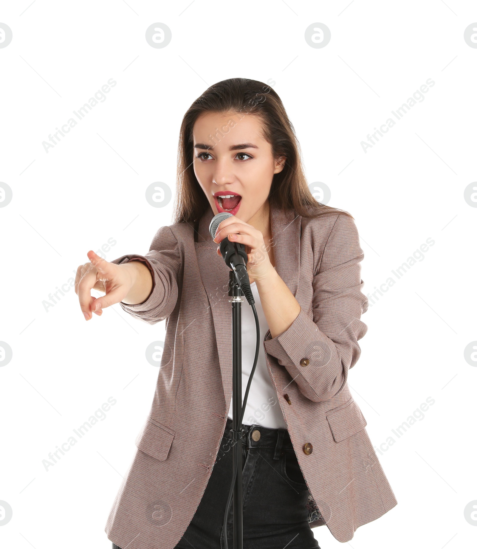 Photo of Young stylish woman singing in microphone on white background