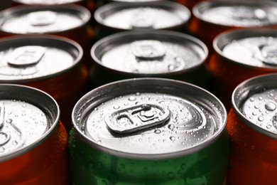 Photo of Energy drink in wet cans, closeup. Functional beverage