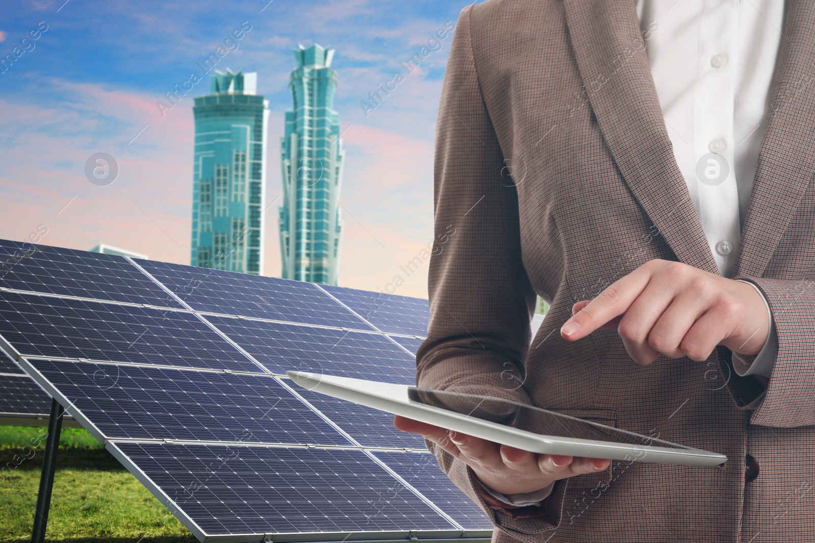 Image of Businesswoman with tablet near solar panels and beautiful view of cityscape. Alternative energy source