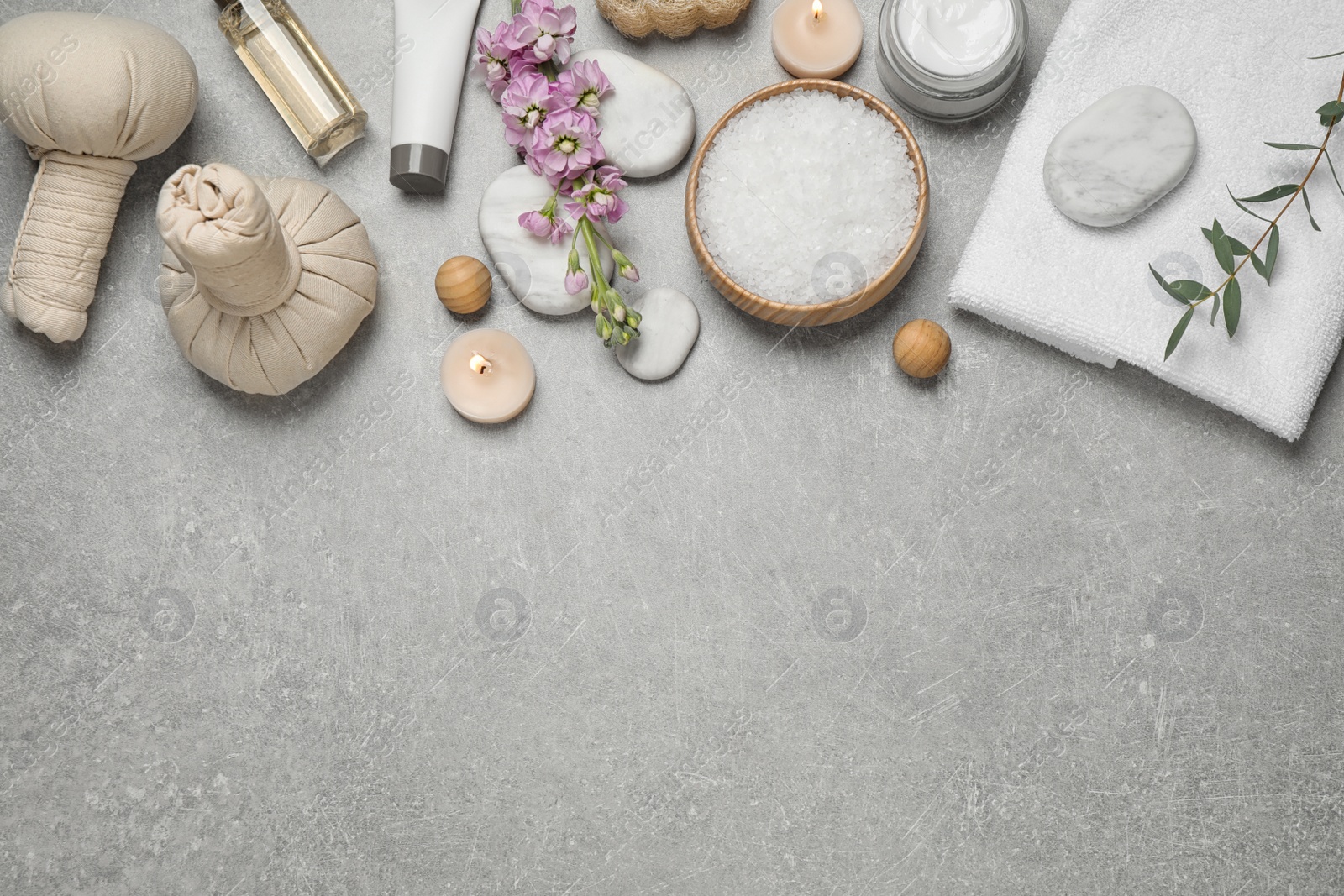 Photo of Flat lay composition with cosmetics on grey marble table, space for text. Spa treatment