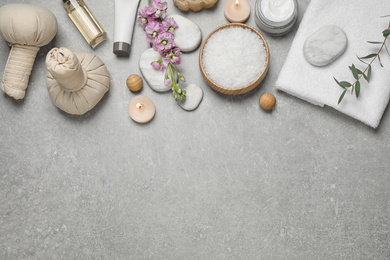 Photo of Flat lay composition with cosmetics on grey marble table, space for text. Spa treatment