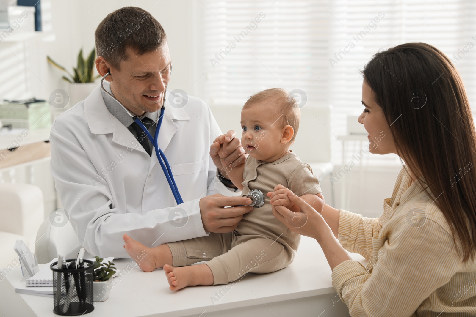 Photo of Mother with her cute baby visiting pediatrician in clinic