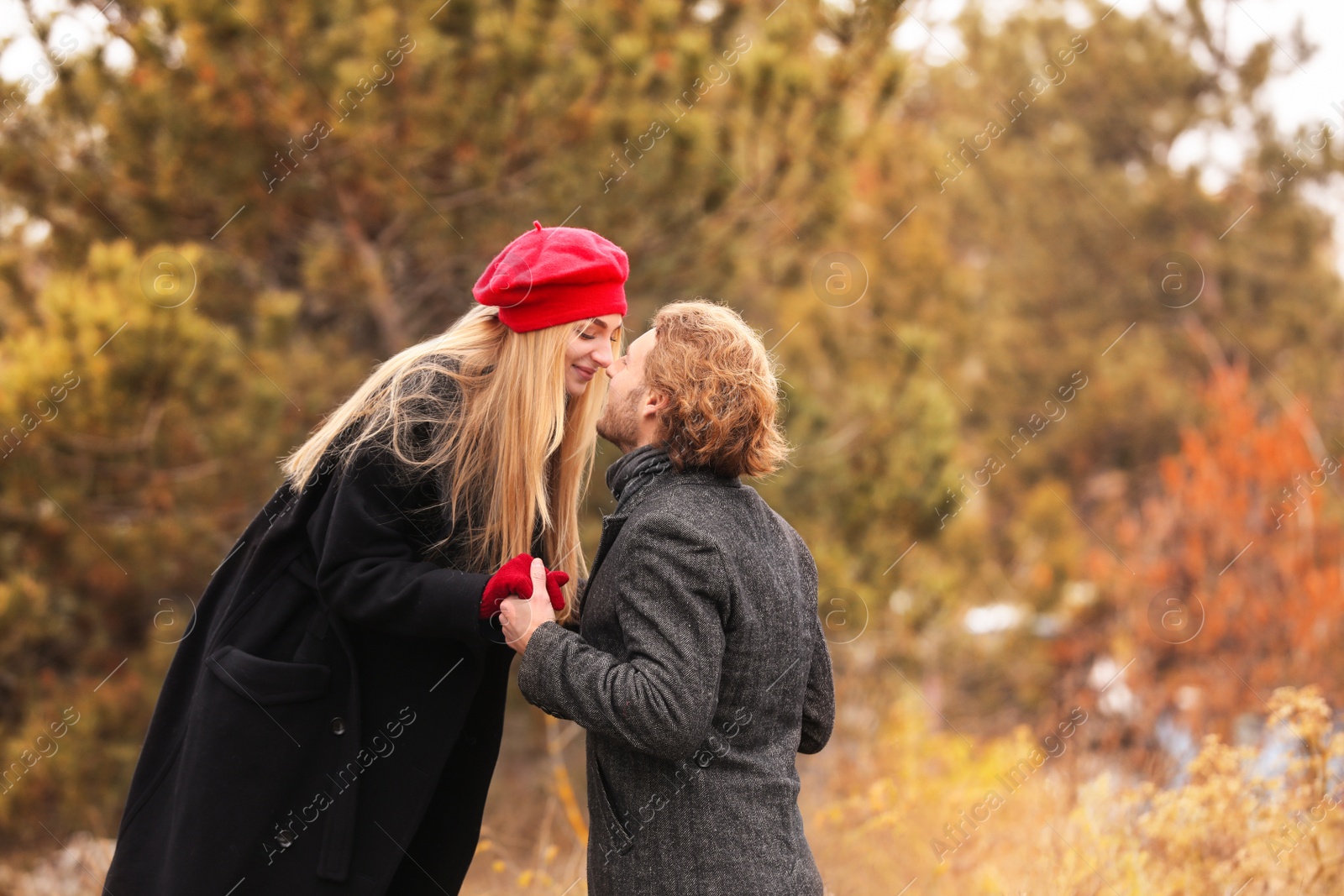 Photo of Young romantic couple in park on autumn day