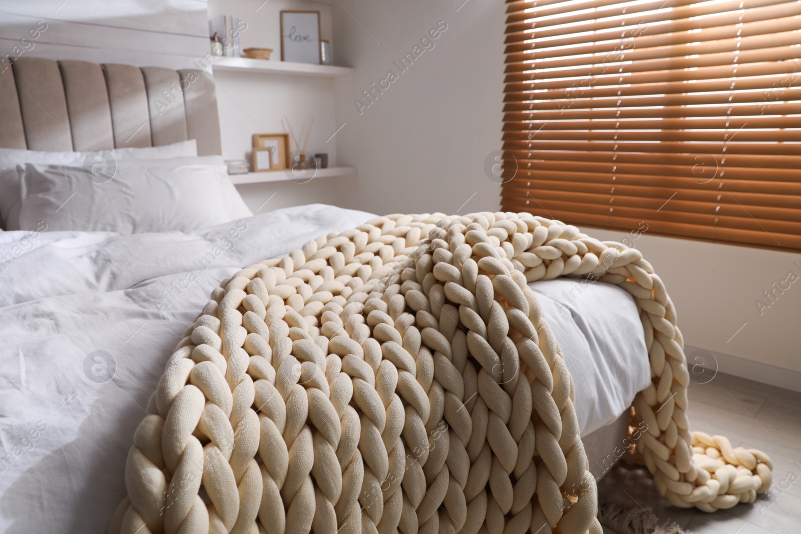 Photo of Soft chunky knit blanket on bed indoors