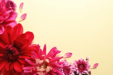 Photo of Flat lay composition with beautiful dahlia flowers and space for text on color background