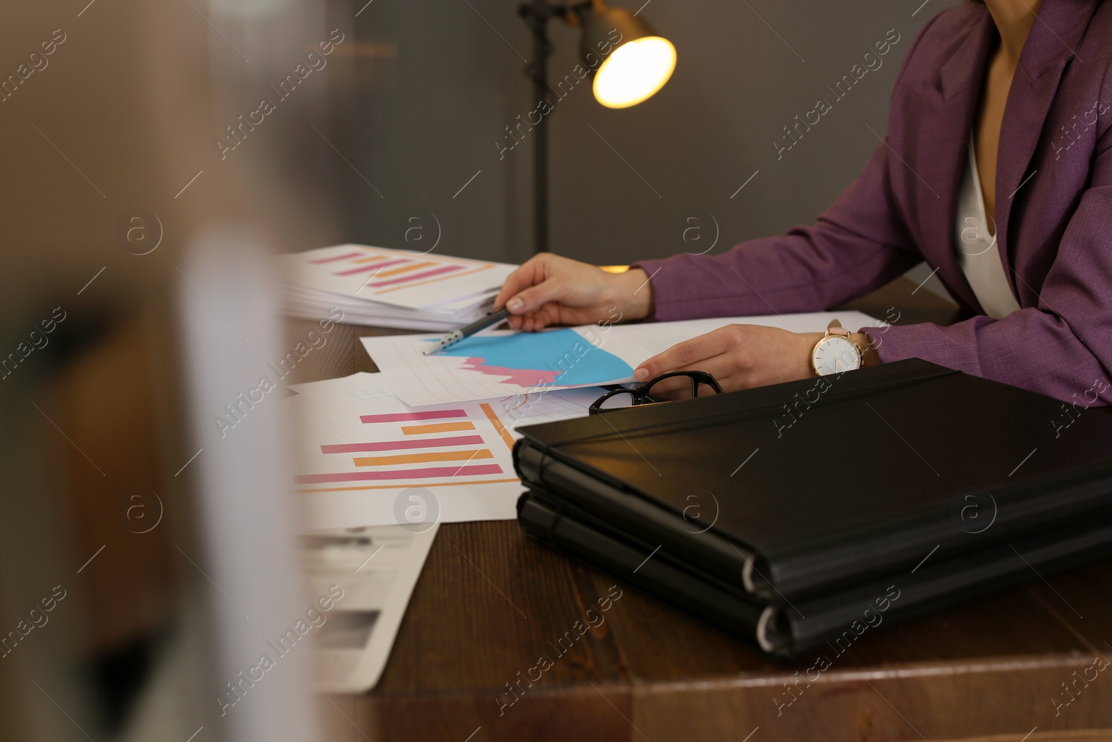 Photo of Businesswoman working with documents at office table, closeup