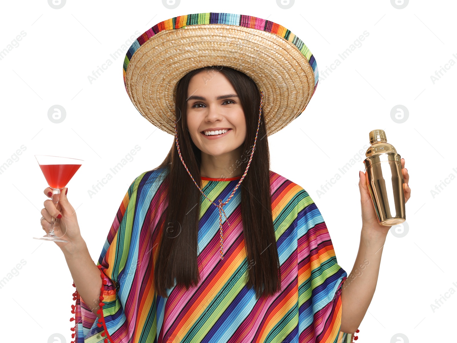 Photo of Young woman in Mexican sombrero hat and poncho with shaker and cocktail on white background