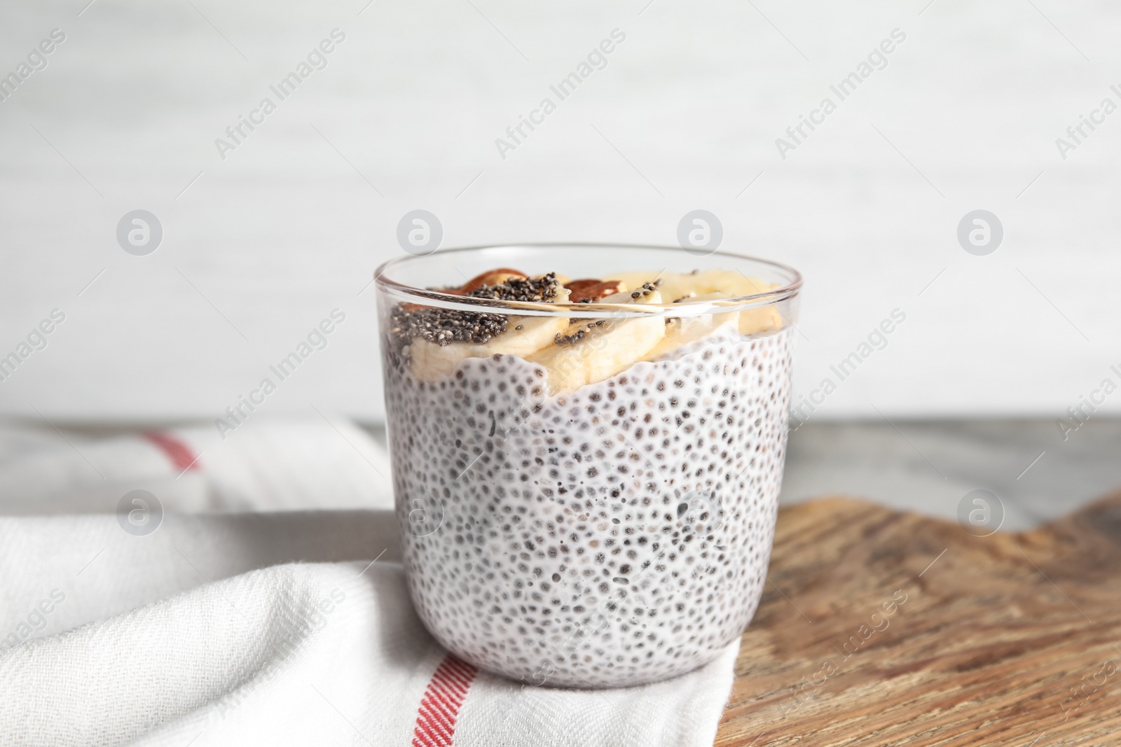 Photo of Dessert bowl of tasty chia seed pudding with banana on table