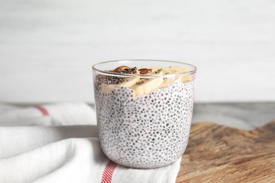 Dessert bowl of tasty chia seed pudding with banana on table