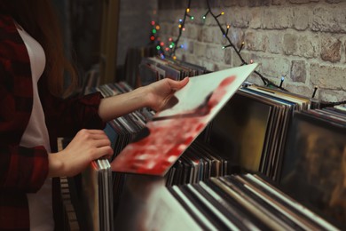 Woman choosing vinyl records in store, closeup