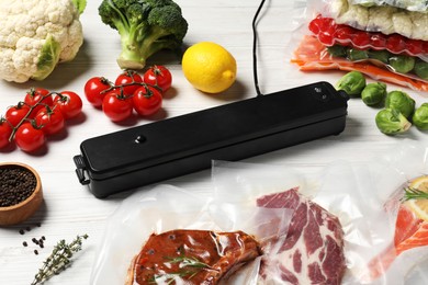 Photo of Vacuum packing sealer and different food products on white wooden table