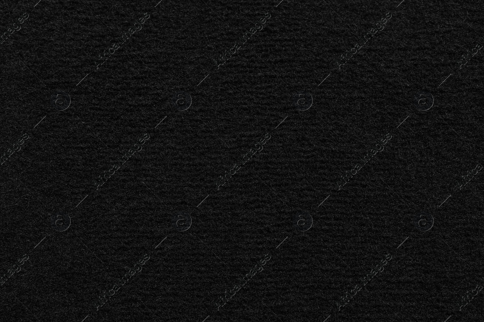 Photo of Texture of black car floor carpet as background, top view