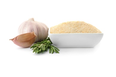 Bowl of dry garlic powder and rosemary on white background