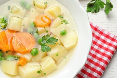 Bowl of fresh homemade vegetable soup on table, closeup