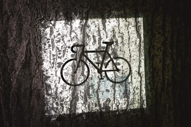 Photo of Traffic sign Local Bicycle Route painted on wooden bark, closeup
