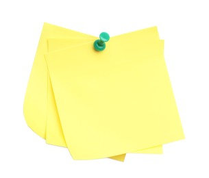 Blank yellow notes pinned on white background, top view