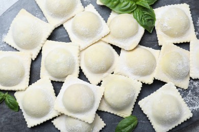 Photo of Homemade uncooked ravioli on board, top view