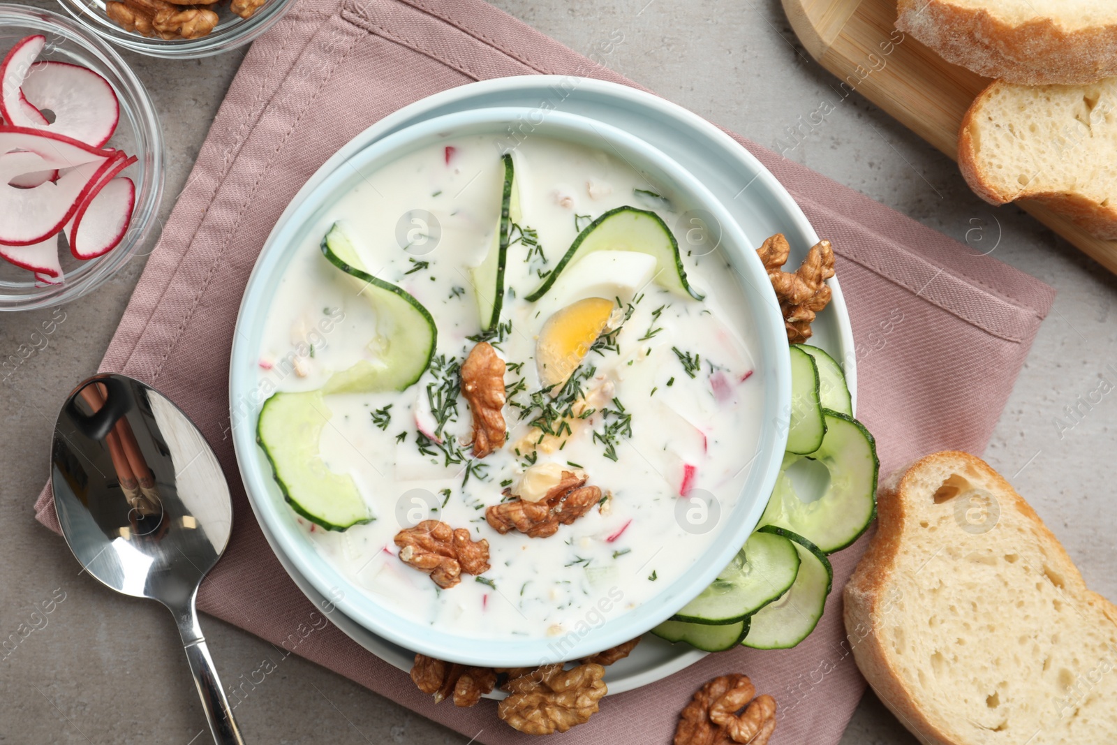 Photo of Delicious cold summer soup on grey table, flat lay