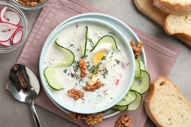 Photo of Delicious cold summer soup on grey table, flat lay