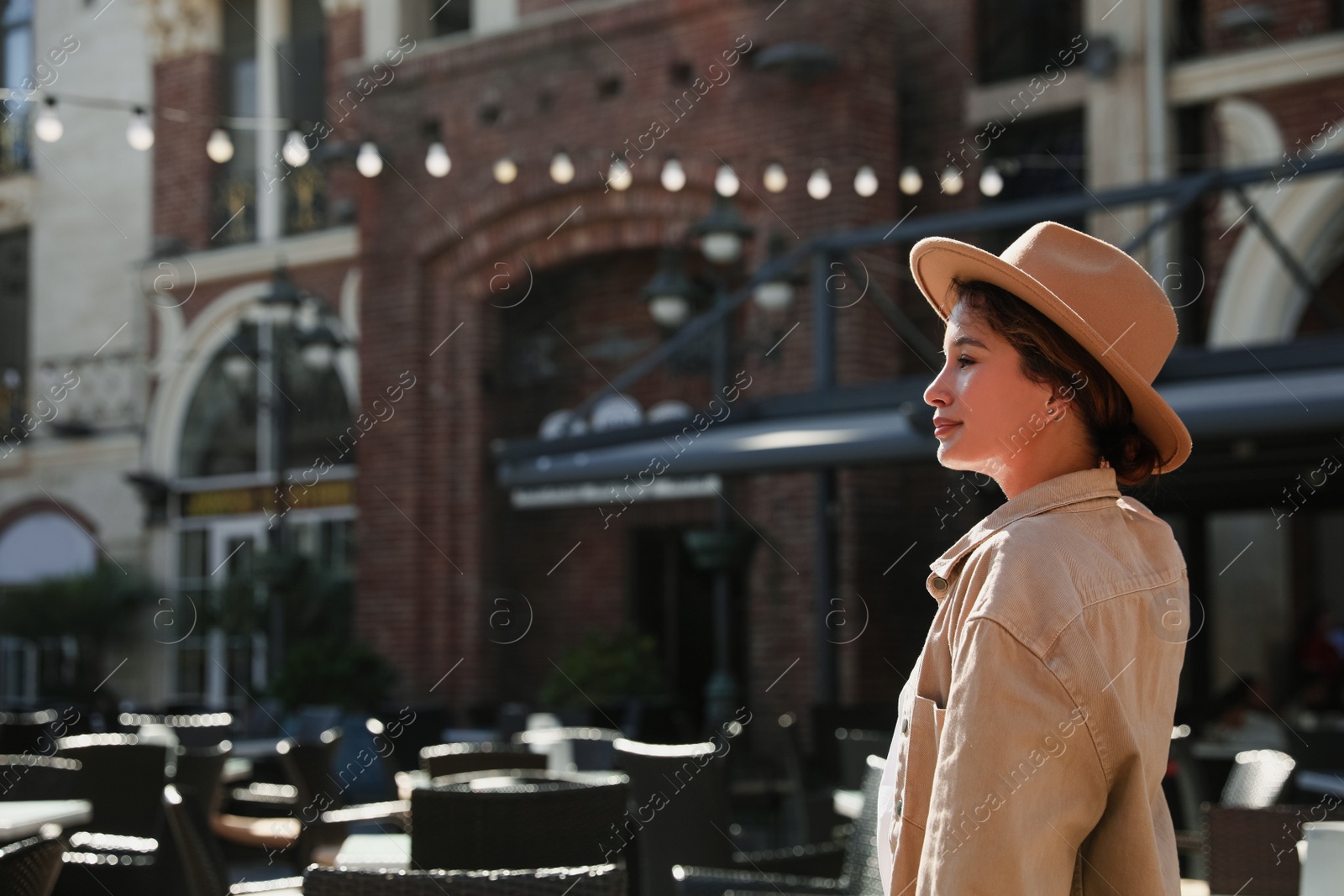 Photo of Portrait of happy young woman on city street