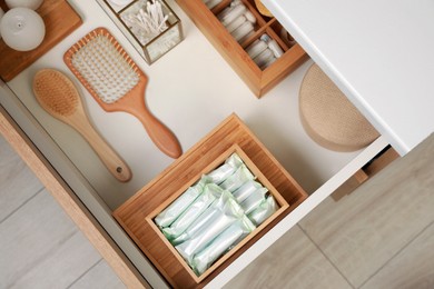 Photo of Keeping tampons and other self care products in drawer, top view