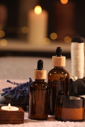 Photo of Composition with spa products and dry lavender flowers on soft light surface, closeup