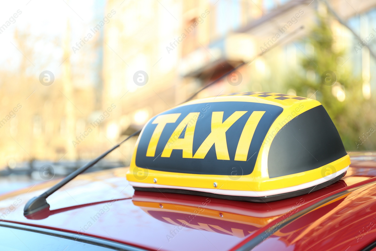 Photo of Roof light with word TAXI on car outdoors