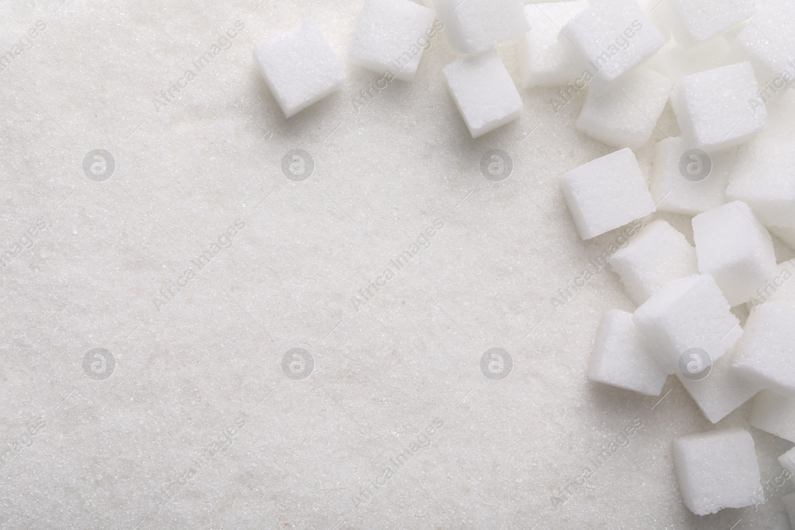 Photo of Different types of sugar as background, top view. Space for text