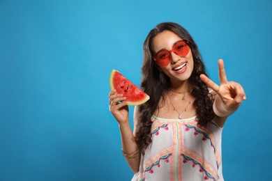 Beautiful young woman with watermelon on blue background. Space for text