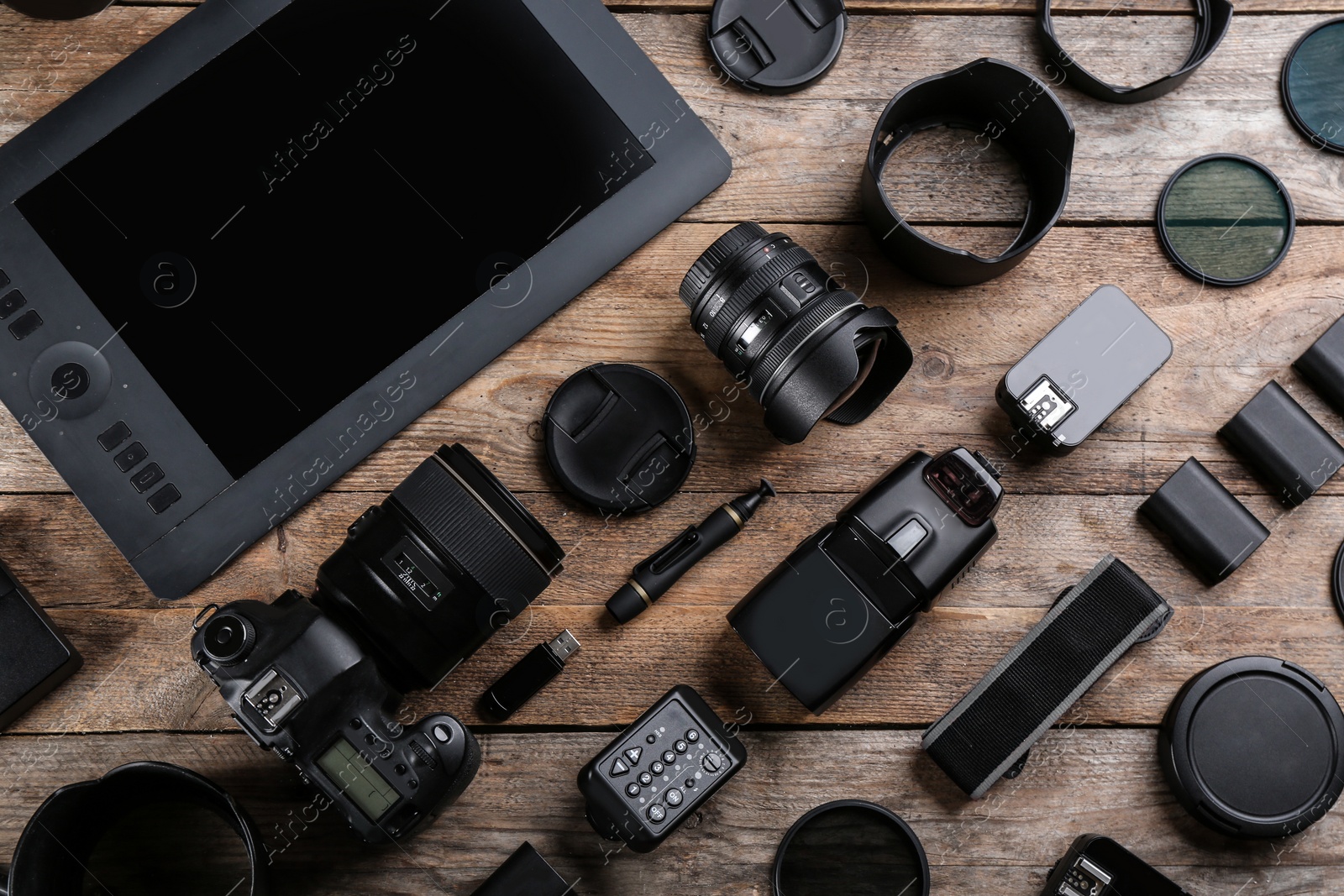 Photo of Flat lay composition with equipment for professional photographer on wooden table