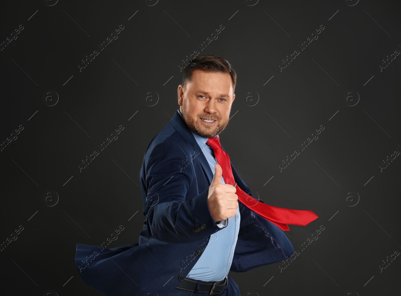 Photo of Portrait of happy mature man on black background