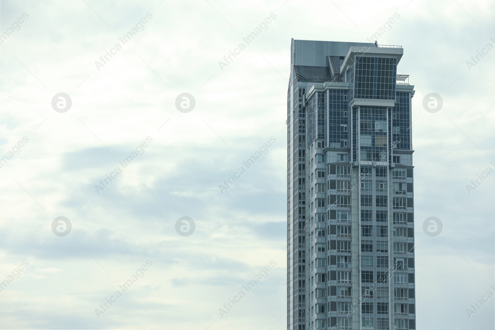 Photo of Modern building against blue sky. Space for text