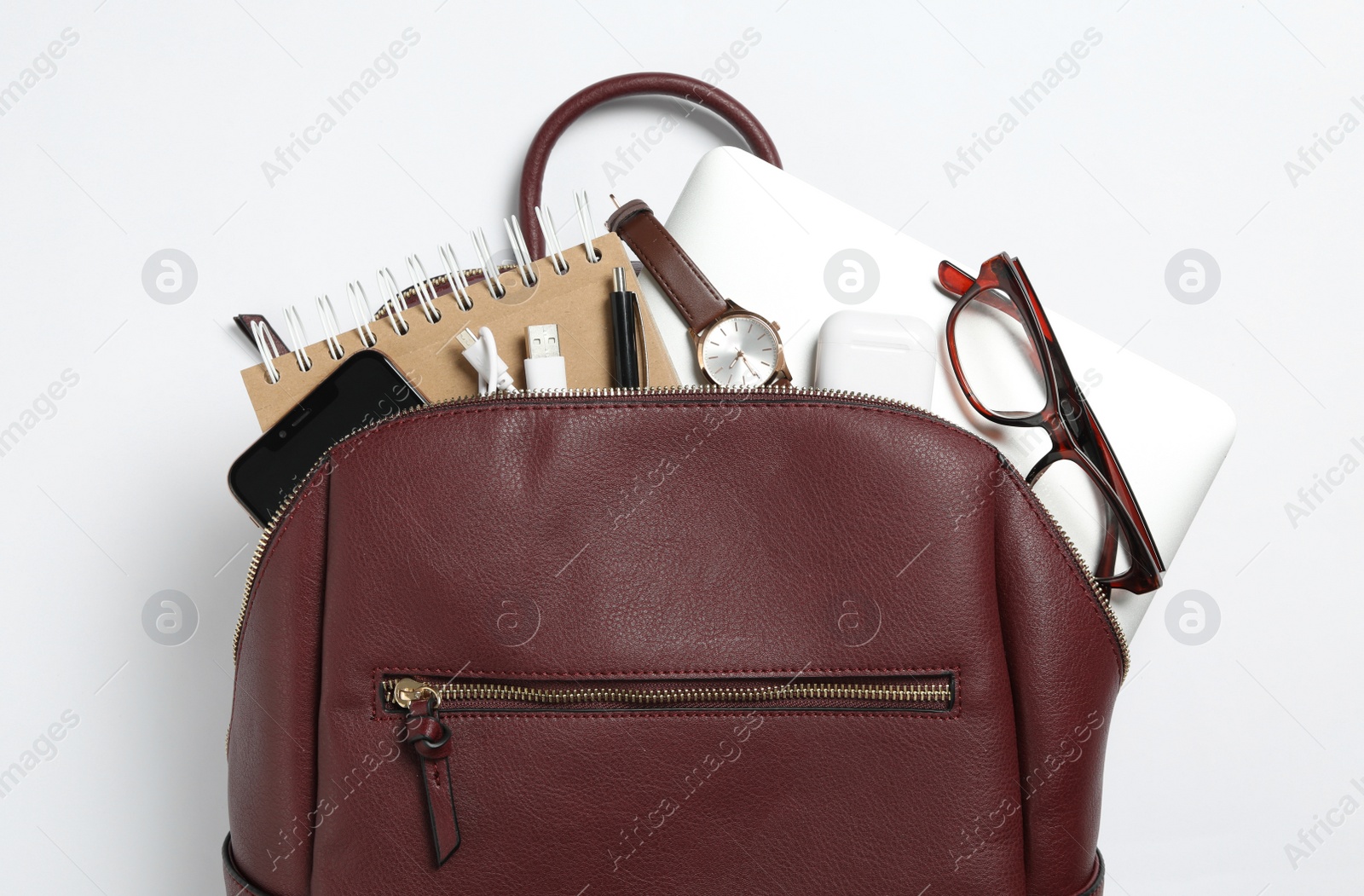 Photo of Stylish urban backpack with different items on white background, top view