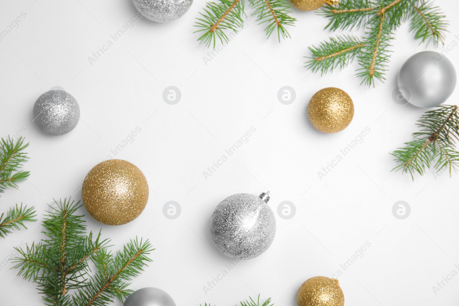 Photo of Composition with Christmas tree branches and festive decor on white background