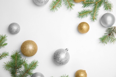 Composition with Christmas tree branches and festive decor on white background