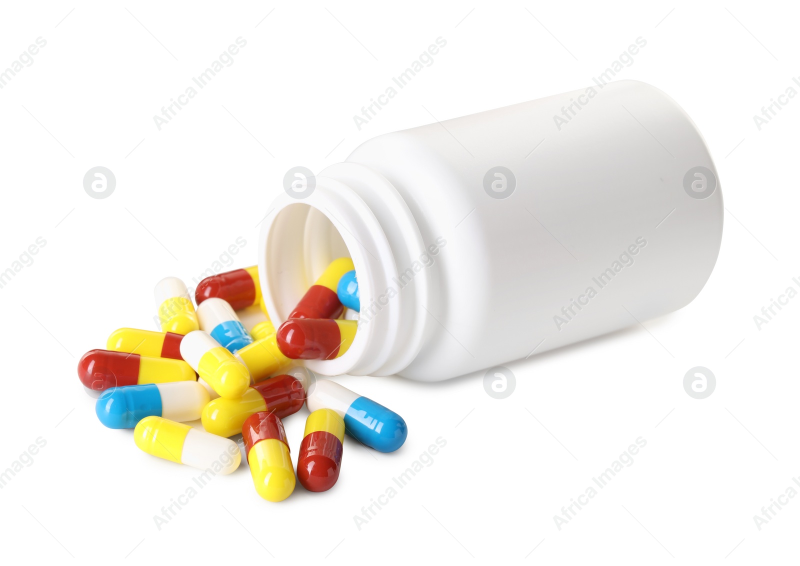 Photo of Scattered antibiotic pills and bottle isolated on white