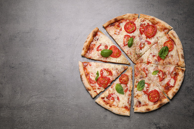 Photo of Delicious pizza Margherita on grey table, flat lay. Space for text
